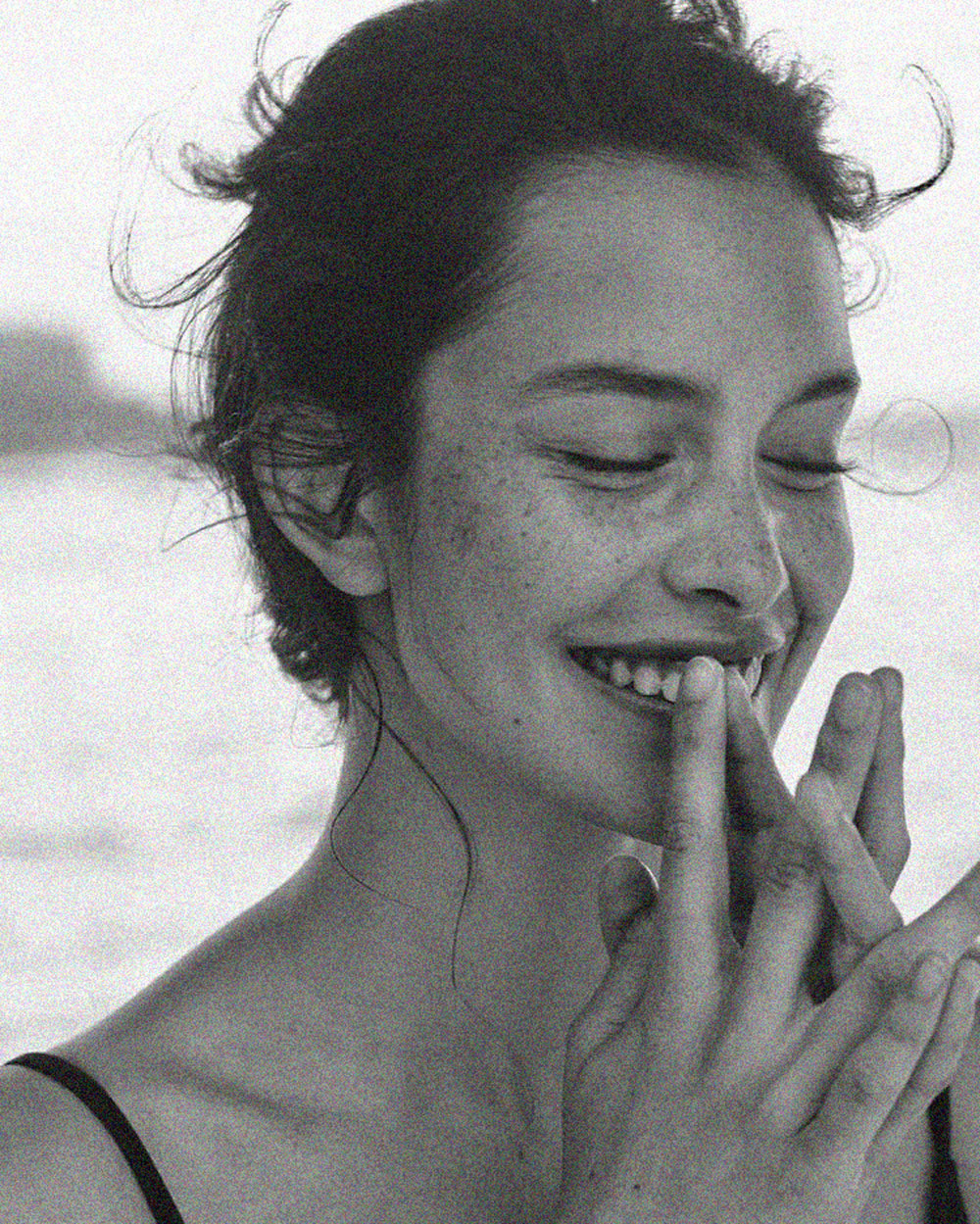 A girl with freckles smiling