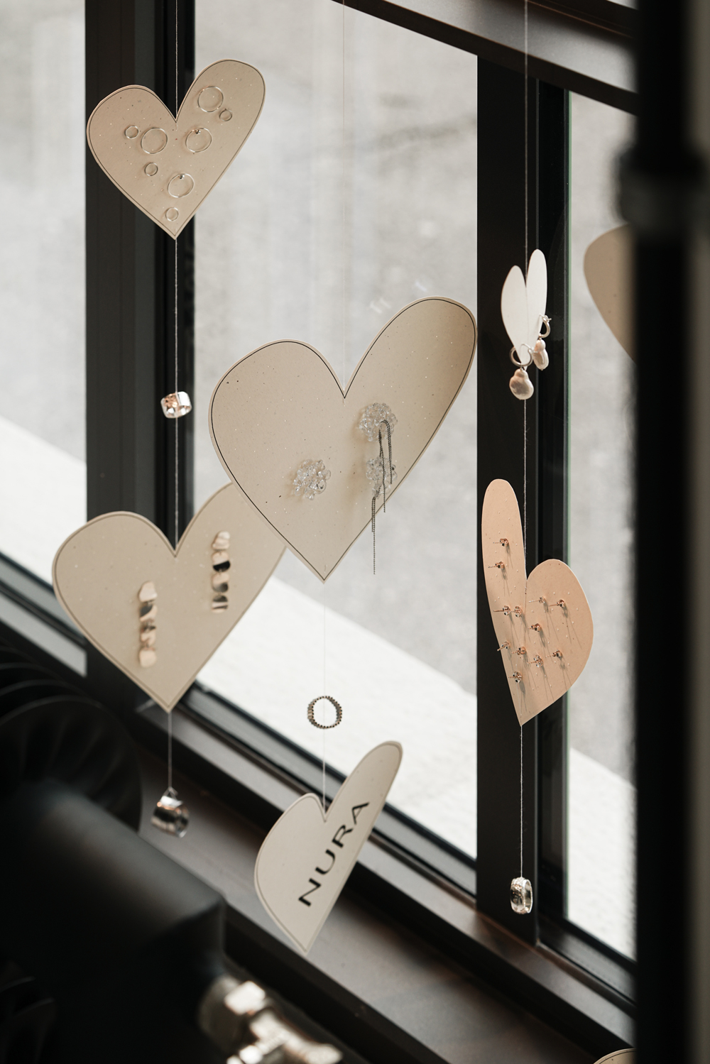 paper hearts hanging with jewellery dispaly - NURA